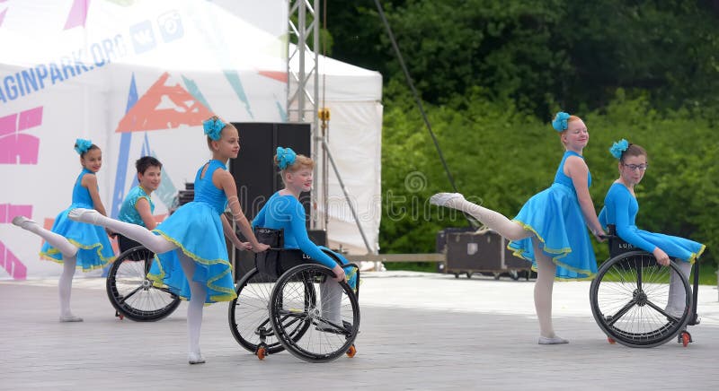 Children in wheelchairs are dancing on the stage. The fulcrum festival