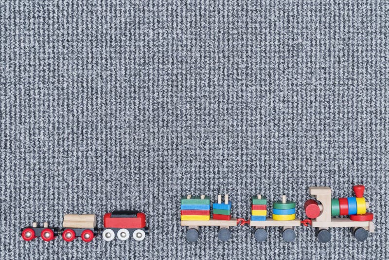Children wooden trains on the carpet stock image