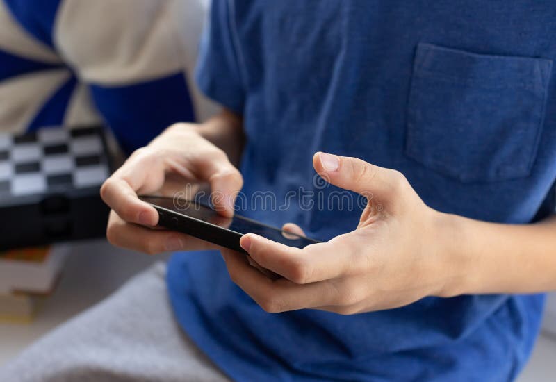 Young Boy and Girl Play Games and Listen To Music on Mobile Phones Stock  Photo - Image of hand, gamer: 135473906