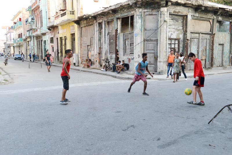 Childs playing football on the street stock photography Childs playing football on the street stock photography