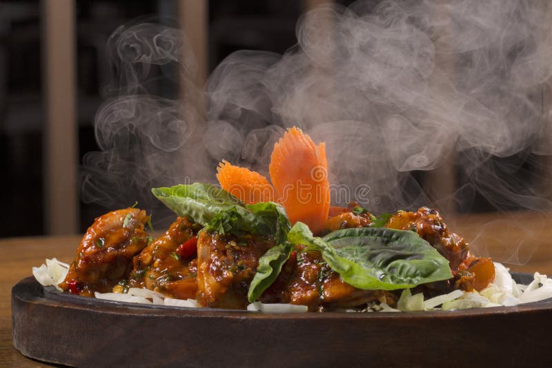 Chili Chicken on hot plate stock photo. Image of base 193290128