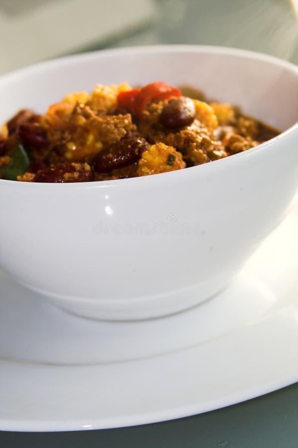 White porcelain bowl with chili con carne, plate,