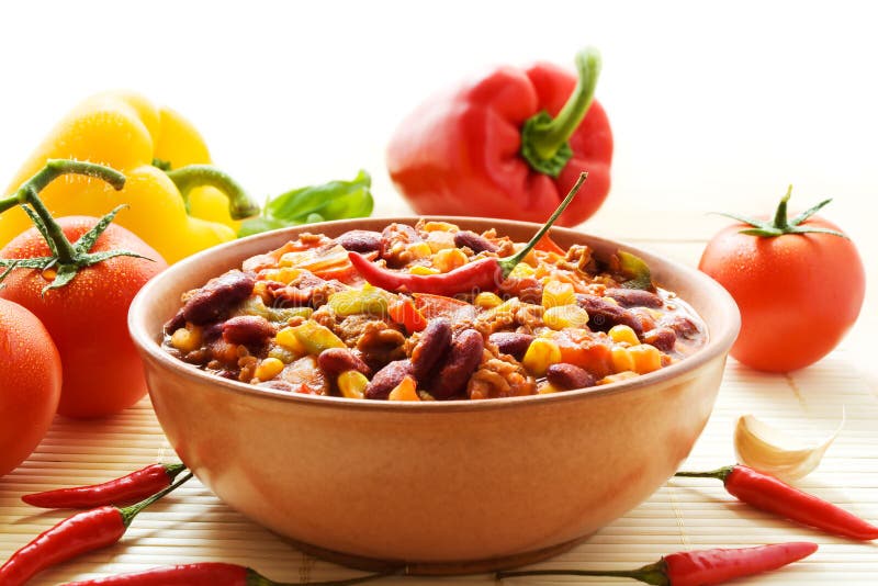 Bowl of chili con carne decorated with ingredients.