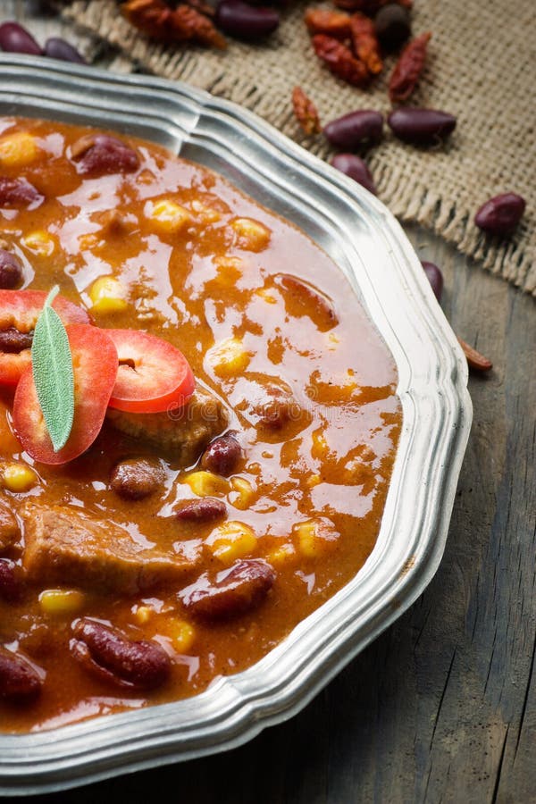 Chili con carne plate. Mexican traditional dish in rustic setting