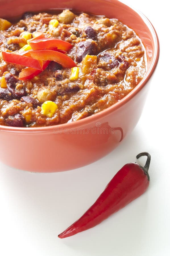 Chili con carne in a bowl with red chili peppers