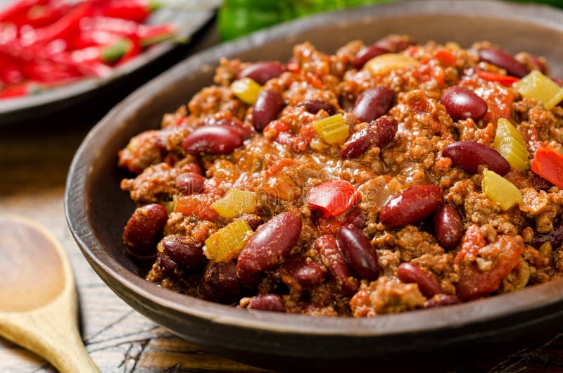 A hot spicy bowl of chili con carne with peppers.