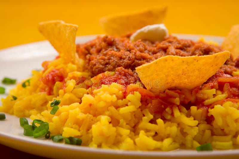 Chili con carne with yellow rice and nachos