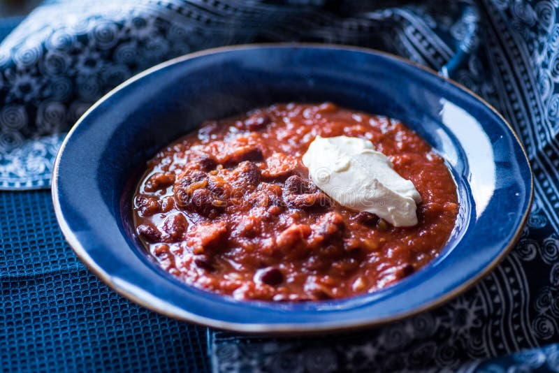 Chili Con Carne with Creme Fraiche Stock Photo - Image of blue, dish ...