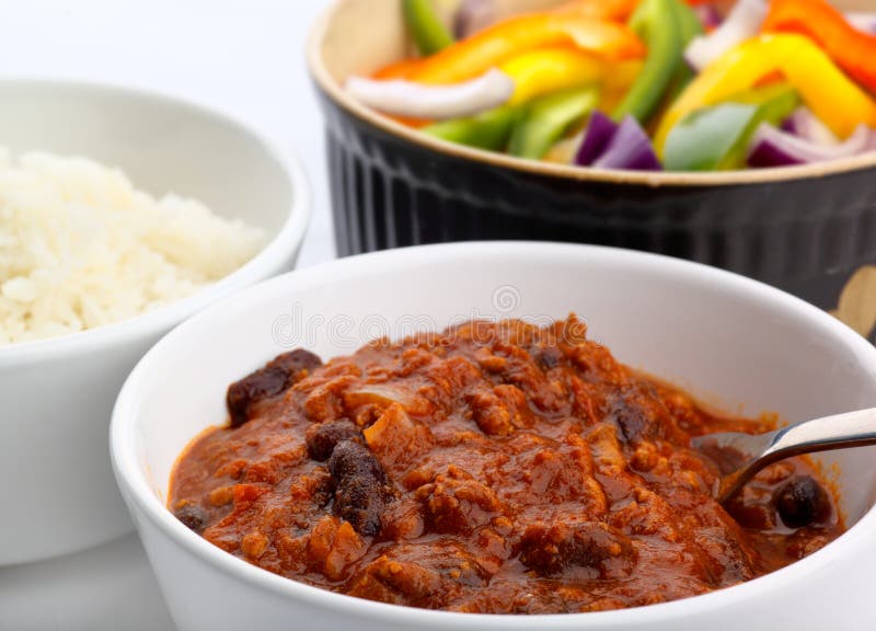 A meal of freshly made Chili Con Carne with rice and bell pepper and onion salad. A meal of freshly made Chili Con Carne with rice and bell pepper and onion salad