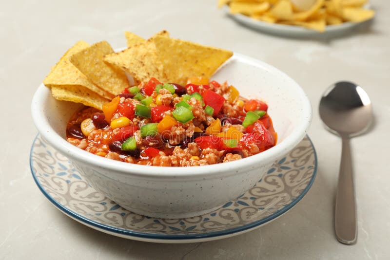 Chili Con Carne Served with Tortilla Chips in Bowl on Table Stock Photo ...