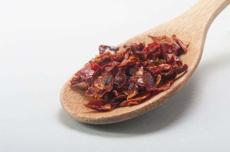 Chili peppers wooden spoon stock images