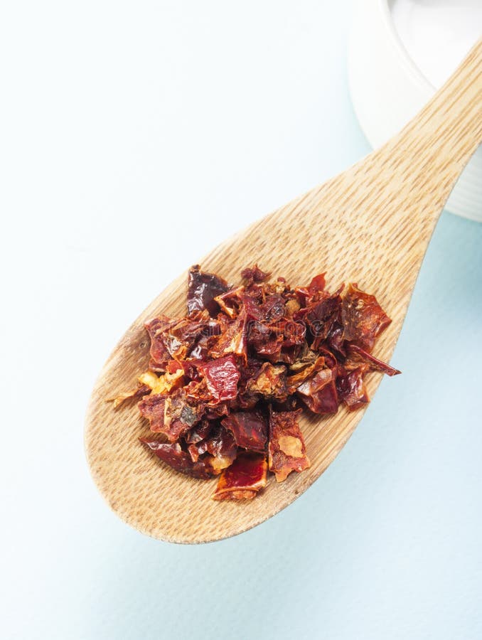Chili peppers wooden spoon stock photography