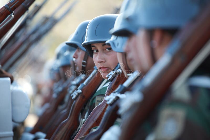 Santiago, Chile - September 15, 2011: A woman soldier marching in a rehearsal of the great military parade in commemoration of the independence of Chile. Santiago, Chile - September 15, 2011: A woman soldier marching in a rehearsal of the great military parade in commemoration of the independence of Chile.