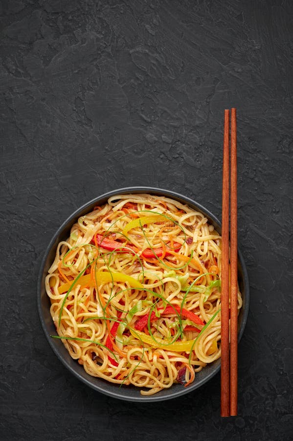Chilli Garlic Hakka Noodles in Black Bowl on Dark Slate Table Top. Indo ...