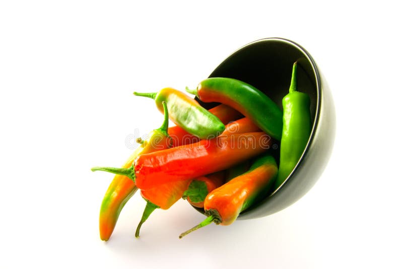 Chillis Spilling out of a Black Bowl