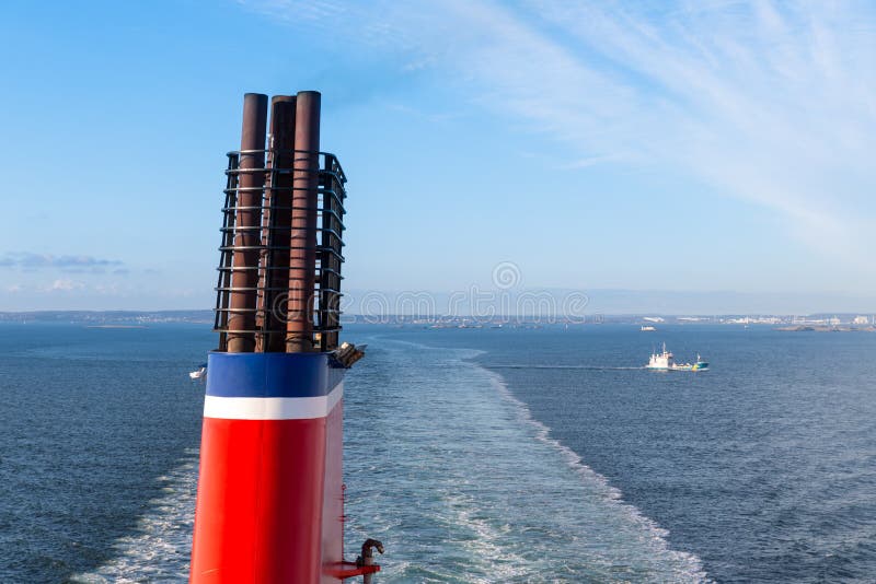 Chimney of a ship sailing at a blue sea