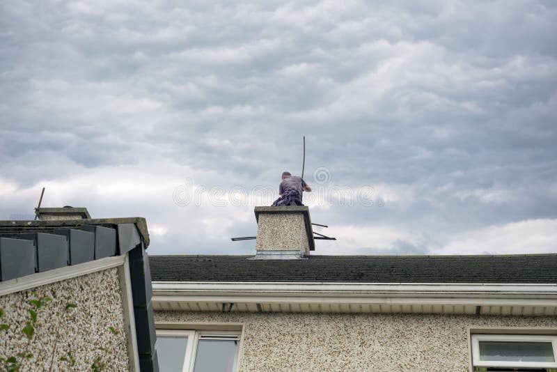 Chimney sweep busy cleaning chimney