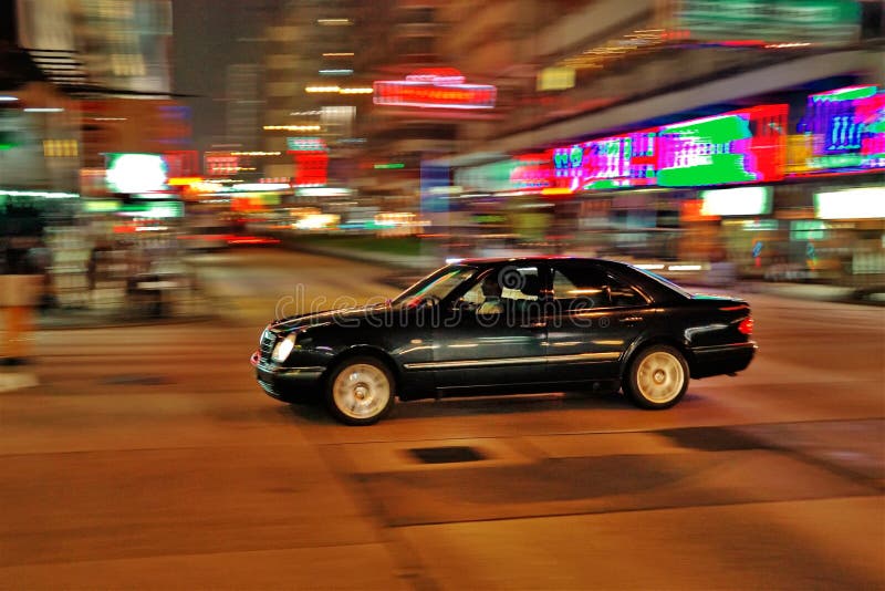 Speeding car in Hong Kong by night