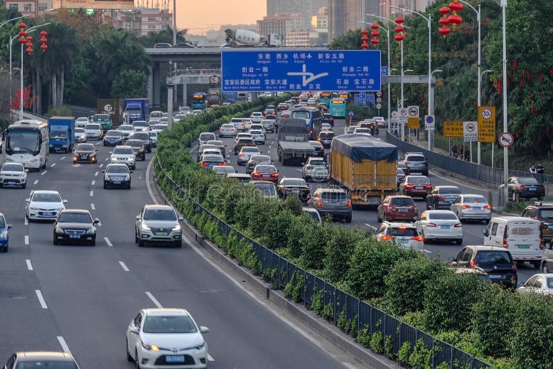 Evening traffic in big city, cars on divided highway road, traffic jam at street, busy urban view at sunset. royalty free stock photo Evening traffic in big city, cars on divided highway road, traffic jam at street, busy urban view at sunset. royalty free stock photo