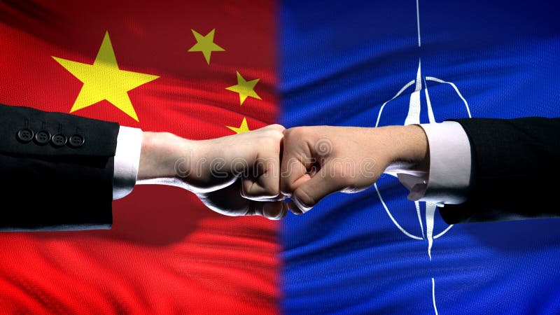 China vs NATO conflict, international relations crisis, fists on flag background stock photography China vs NATO conflict, international relations crisis, fists on flag background stock photography
