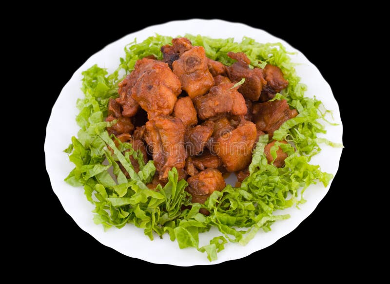 Chinese food. Fried pork ribs with shredded lettuce, isolated on black. Chinese food. Fried pork ribs with shredded lettuce, isolated on black.