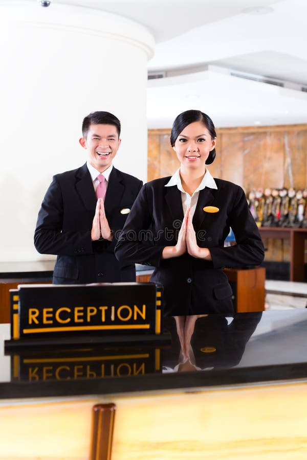 Chinese Asian reception team at hotel front desk