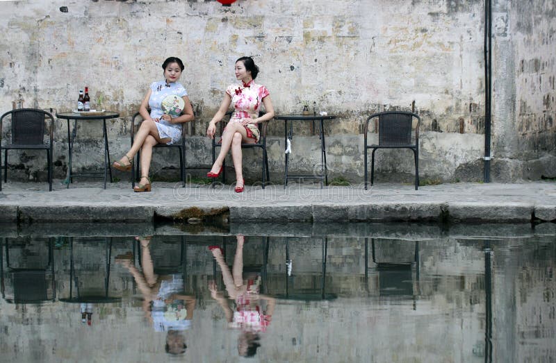 Chinese beauty girlfriends in cheongsam enjoy free time