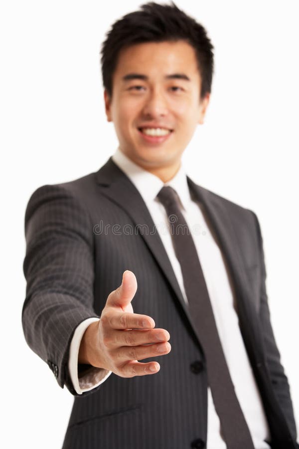 Chinese Businessman Reaching Out To Shake Han royalty free stock photos