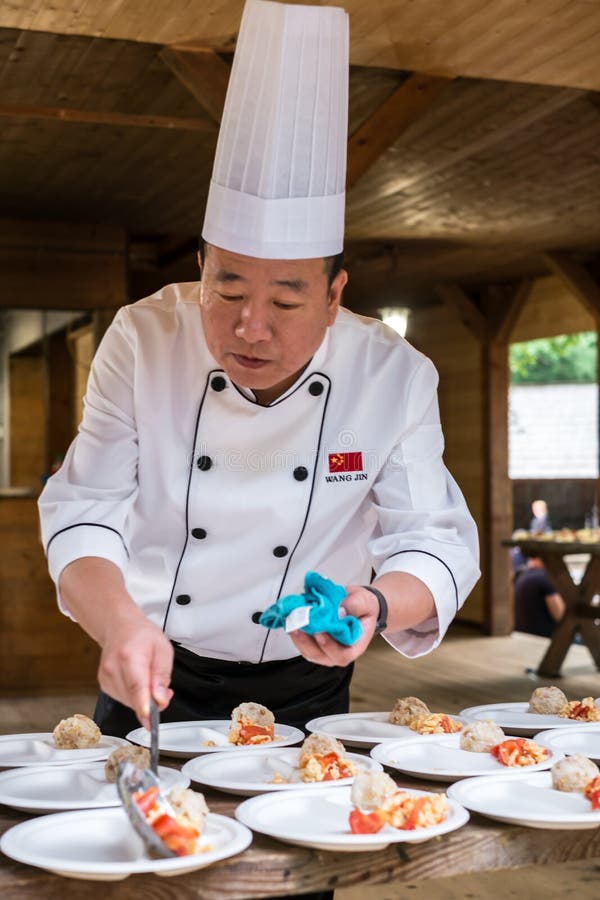 Chinese Cook Arranges Food On