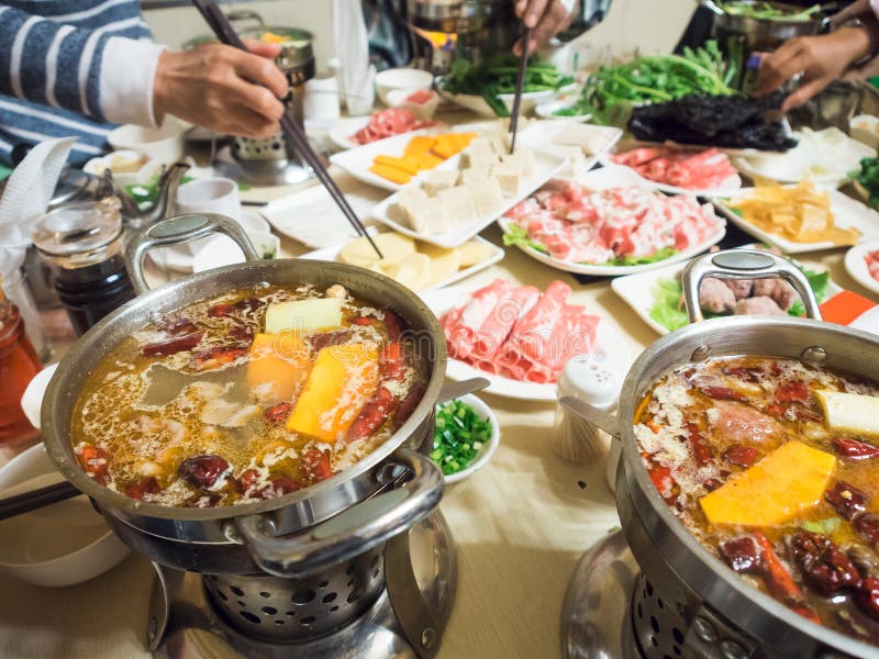 Chinese dinning dip sliced meat in chilli hot soup