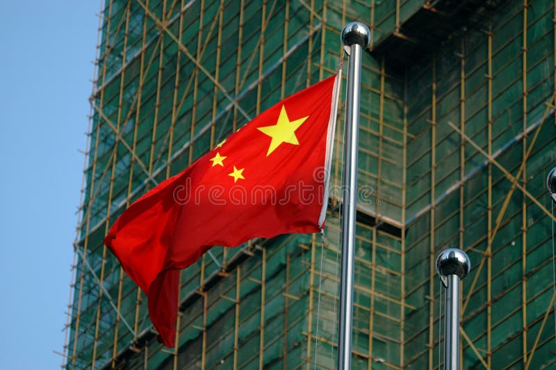 Chinese flag with buildings behind