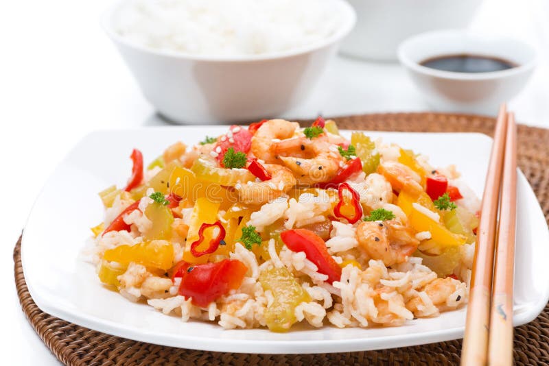 Chinese food - white rice with vegetables and shrimps on a plate