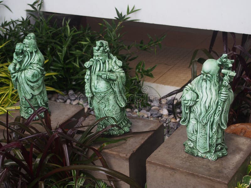 Chinese god of fortune, prosperity and longevity figurine called three goddesses Fu Lu Shou in the small garden royalty free stock image Chinese god of fortune, prosperity and longevity figurine called three goddesses Fu Lu Shou in the small garden royalty free stock image