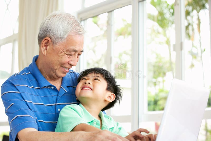 Chinese Grandfather And Grandson Using Laptop royalty free stock image Chinese Grandfather And Grandson Using Laptop royalty free stock image