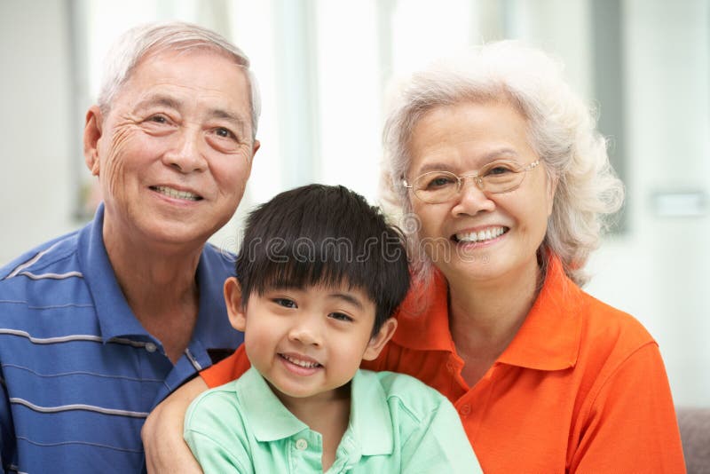 Chinese Grandparents With Grandson Relaxing At Hom royalty free stock images Chinese Grandparents With Grandson Relaxing At Hom royalty free stock images