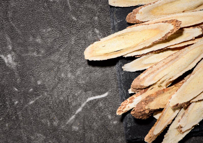 Chinese herbal medicines -- Astragalus on stone background