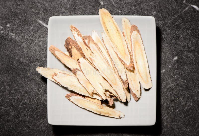 Chinese herbal medicines -- Astragalus on stone background