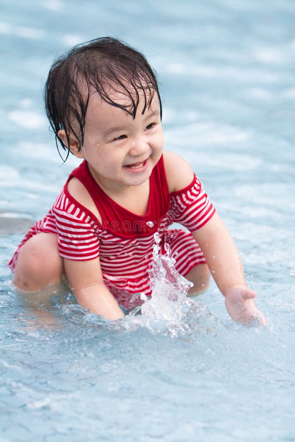 Chinese Little Girl Playing in Water