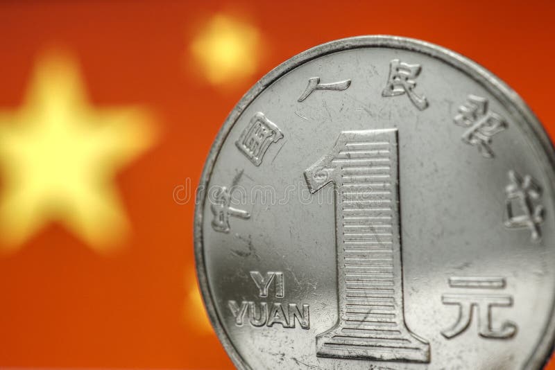 Chinese money. 1 yuan coin on the background of the flag of the China PRC close-up. Economy, national currency exchange rate