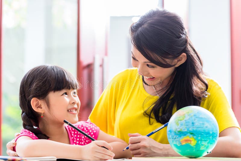Chinese mother doing school homework with child royalty free stock images Chinese mother doing school homework with child royalty free stock images