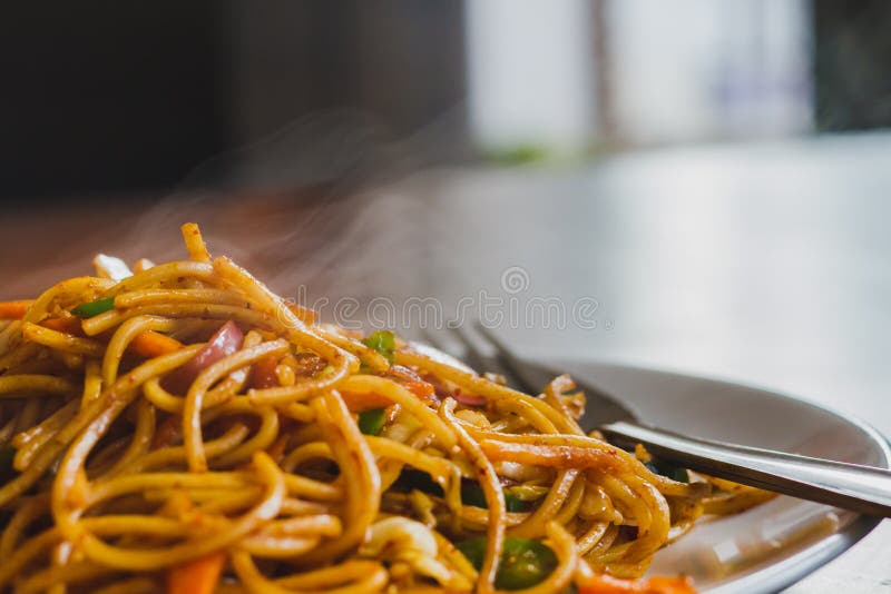 Chinese Noodles, Chowmein on a Plate with Spoon and Fork