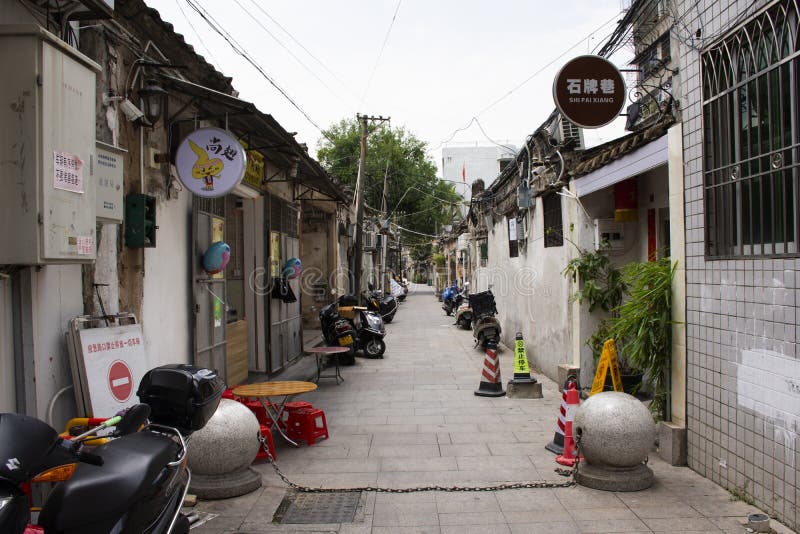 Chinese people walking in small alley at Paifang Street go to house in old town and ancient city center of Chaozhou