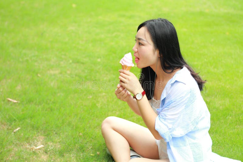 Chinese Portrait of young happy woman eating ice-cream royalty free stock images Chinese Portrait of young happy woman eating ice-cream royalty free stock images