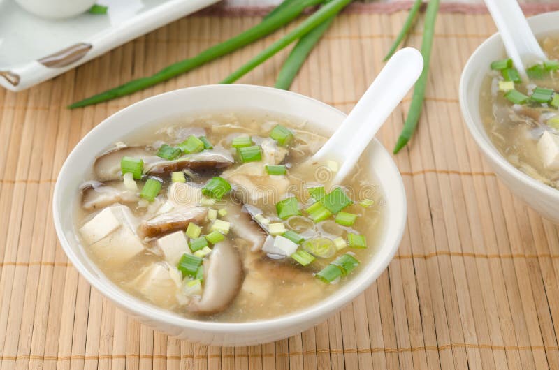 Chinese spicy soup with egg, shiitake mushrooms, tofu and green