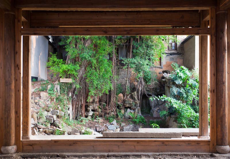 Chinese style backyard viewed from a old empty house. This backyard and house are a typical architectural style of the Ming and Qing Dynasties in southeast China. Pillar column garden stock images, royalty-free photos and pictures