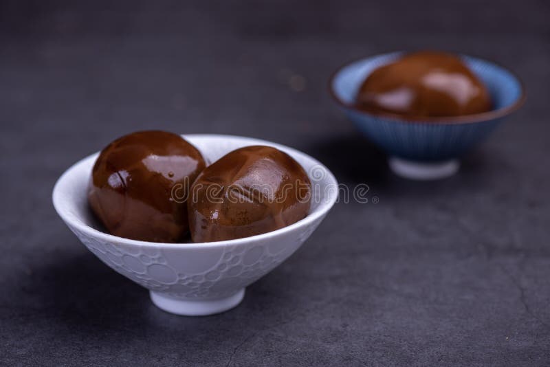 Chinese Tea Eggs, Cut or Whole Marinated Eggs in Dark Background Stock