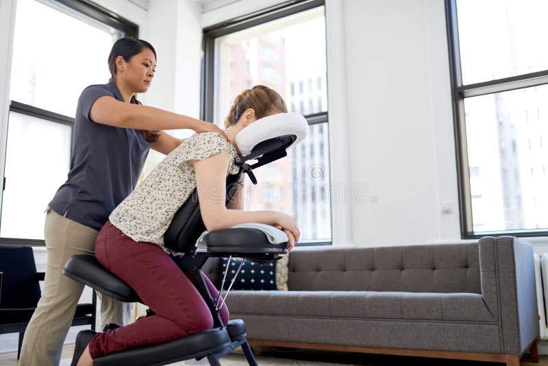 Chinese Woman Massage Therapist Giving A Neck And Back Pressure Stock