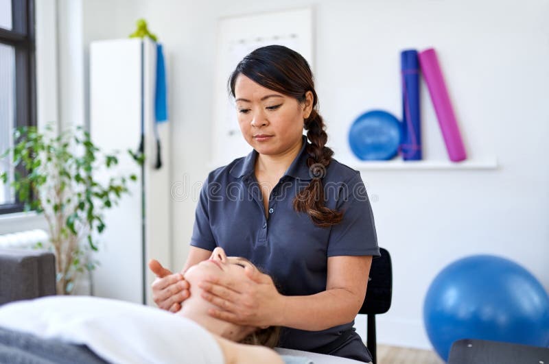 Chinese Woman Massage Therapist Giving A Treatment To An Attract Stock