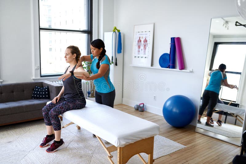 Chinese Woman Massage Therapist Giving A Neck And Back Pressure