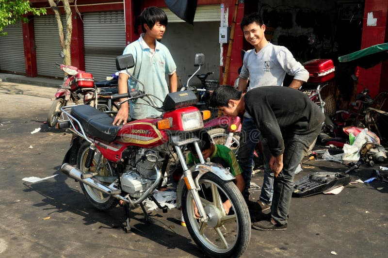 Pixian Old Town, China: Youths with Motorcycle